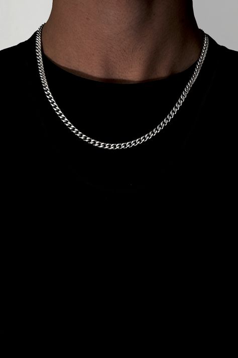 This is a photo of a 5mm Cuban Link Chain for Men, a streetwear fashion accessory made from stainless steel with a silver finish. Pictured: Silver necklace featuring a durable, stainless-steel chain with a unique cuban link design. It's an affordable accessory from our Etsy Shop that adds a stylish touch to any outfit. #CubanLinkChain #MensAccessory #5mmNecklace #StainlessSteel #Silver #Streetwear #FashionAccessory Street Wear Jewelry Men, Guy Chains, Cheap Silver Chain Necklace For Streetwear, Black Jewelry With Silver Chain For Streetwear, Silver Chain Men, Stainless Steel Silver Chain Necklace For Streetwear, Cuban Link Silver Chain Necklace For Streetwear, Stainless Steel Chain Link Necklace For Streetwear, Cuban Chain Men