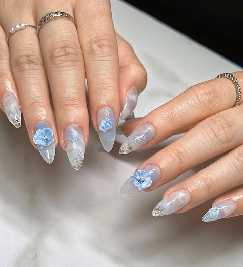 ☁️ Airy Orchids 🧊 Medium Almond Gel-X, client requested for a light blue palette with 3d orchids to match 💙 #gelxinspo #gelxnails #orchidnails #nailinspo #nailart #naildesign #almondnails #trendynails #pinterestnails #nails2inspire #3dnails #3dnailart #texturednails Blue Nail Inspo Aesthetic, Light Blue Nails With Design Almond, Tropical Blue Nails, Light Blue Almond Nails Design, Nails Almond Light Blue, Orchid Nail Designs, Blue 3d Nails, Light Blue Nails With Design, Light Blue Palette