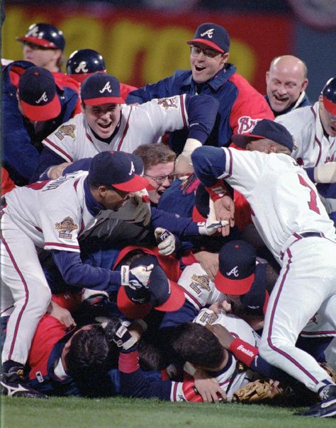 In this Oct. 28, 1995, file photo, the Atlanta Braves celebrate their 1995 World Series win against the Cleveland Indiants at Atlanta Fulton County Stadium in Atlanta. After a one-year delay caused by the 7 and a half-month players' strike, the expanded playoffs began in 1995, when teams played a 144-game schedule because of the walkout. The top teams met that October, with Atlanta defeating Cleveland in six games. (AP Photo/Andrew Innerarity, File) Atlanta Braves Wallpaper, Georgia Peaches, Atlanta Braves World Series, Baseball Pitching, Atlanta Braves Baseball, Baseball Teams, Chop Chop, Braves Baseball, Baseball Photos