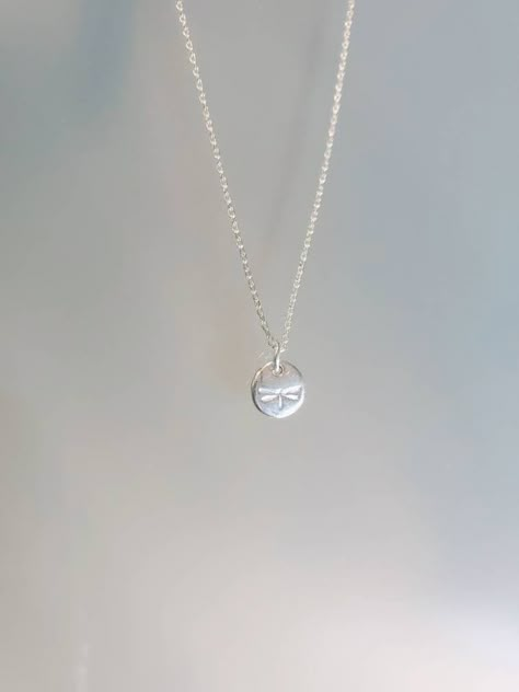 "This teenie tiny sterling silver dragonfly charm is so sweet and delicate, it is a perfect every day necklace. The 6mm charm is solid sterling with a tiny dragonfly impression. The charm hangs from a small but strong sterling silver chain and is shown in 17\" length. *If you are unsure of the length you need, or would like to wear this item at different lengths, we now offer an adjustable length option! You can add an adjustable end to your necklace using this link: https://www.etsy.com/listing Sterling Silver Dragonfly Necklace, Silver Dragonfly Necklace, Silver Jewlery, Silver Necklace Simple, Dragonfly Charm, Dragonfly Necklace, Dope Jewelry, From Santa, Jewelry Lookbook