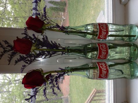 Does anyone else think glass Coke bottles are too pretty to throw away?  Well here is a new use for them, vases! Grunge Vase, Glass Coke Bottle Crafts, Coke Bottle Decor, Coke Bottle Crafts, Glass Coke Bottles, Soda Bottle Crafts, Bottle Picture, Coke Cola, Hobbit Hole