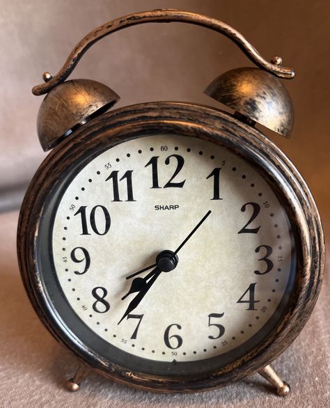 This is a retro-style Sharp desk clock with a rustic brass color. It has a round shape and operates on battery power with quartz movement. The clock features an alarm function and is designed with a vintage/retro style in the 21st century. It is made of plastic and metal, measuring 4.25 inches in length, 5.75 inches in height, and 1.5 inches in width. The clock is in great working condition. Desk Table Top, Shelf Clock, Mantel Shelf, Desk Clock, Desk Table, Brass Color, 21st Century, Quartz Movement, Round Shape