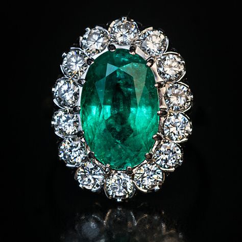 This mid-century vintage French emerald and diamond engagement cluster ring is finely crafted in platinum (head) and 18K white gold (shank). The ring features a sparkling medium green natural emerald likely of Colombian origin.  The oval cut emerald measures 12.62 x 8.15 x 6.30 mm and is approximately 3.59 ct.  The brilliant cut diamonds are bright white (E-F color) and clean (mostly VS clarity). Estimated total diamond weight is 1.40 ct.  The ring is marked with eagle’s head and dog’s head Fren Princess Eugenie Wedding Ring, Green Victorian Rings, Luxury Princess Cut Emerald Ring With Halo Setting, Luxury Emerald Ring With Intricate Design For Anniversary, Luxury Jewelry Ring With Brilliant Cut, Luxury Emerald Wedding Ring With 17 Jewels, Luxury Wedding Emerald Ring With 17 Jewels, Luxury Formal Emerald Ring, Asscher Cut, Luxury Victorian Rings For Formal Occasions