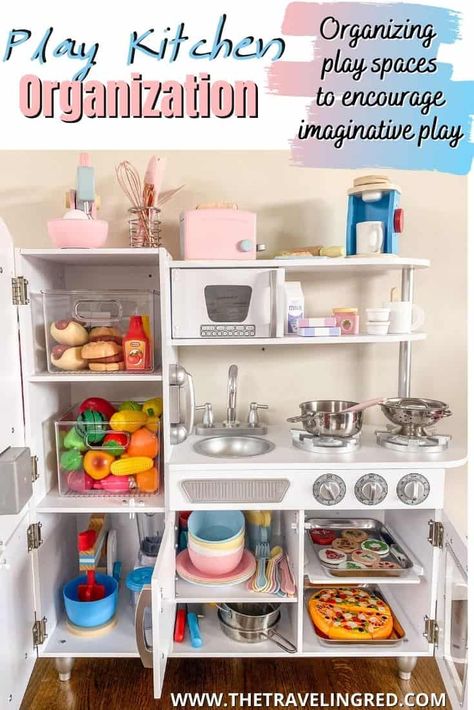 PLAY KITCHEN ORGANIZATION TO ENCOURAGE IMAGINATIVE & PRETEND PLAY by The Traveling Red Play Kitchen Small Space, Play Kitchen Must Haves, Diy Pretend Kitchen, Toy Food Organization, Playroom Kitchen Organization, Pretend Play Organization, Toy Kitchen Storage Ideas, How To Organize Play Kitchen Food, Pretend Play Kitchen Diy