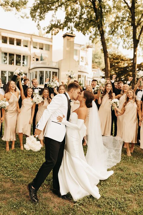 Classic Wedding Bridal Party, Bride And Groom Wearing White, Timeless Wedding Bridal Party, Black Tuxedo Wedding Party, Champagne Tuxedo Wedding, Champagne And Black Wedding Party, Bridal Party Tan Suits, Groom And Bride In White, Black And White Tuxedo Wedding