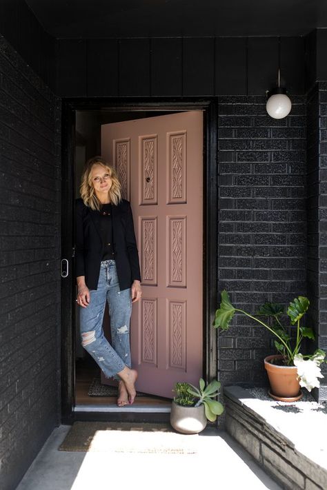 Kirsten Grove standing in front of front door and black brick wall with new Nest Hello System Black Brick House Exterior, Black Brick House, Stained Brick, Brick Ranch Houses, Painted Brick Exteriors, Black Brick Wall, Ranch House Exterior, Painted Brick House, Black Front Doors