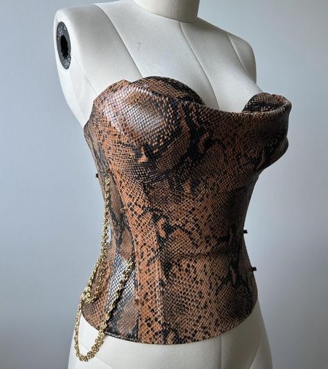 - Finished corset with draped cowl at bust - Corset before draping on second slide Handcrafted with snakeskin print leather 🤎✨ Snake Corset, Corset Patterns, Corset Pattern, London Design, Snakeskin Print, Printed Leather, Snake Print, Snake Skin, Fashion Inspo