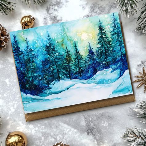 Set of 12 Festive Winter Forest Notecards with Kraft Envelopes Add a burst of festive cheer to your correspondence this season with our enchanting set of 12 notecards, each featuring a vibrant snowy winter forest scene. Printed in stunning jewel tones of bright blues and greens, these cards capture the magical beauty of a winter wonderland, perfect for sending holiday wishes or heartfelt notes to loved ones. Inside, the cards are left blank, allowing your personal message to shine through! This set includes: 12 A2-sized notecards (4.25 x 5.5 inches) 3 distinct winter scenes   12 Kraft envelopes - for an extra touch of rustic charm Perfect for Christmas greetings, thank-you notes, or just spreading a bit of winter magic, these notecards are sure to delight anyone who receives them! High-qua Winter Wishes Cards, Beach Wood Decor, Dade City Florida, Wood Initials, Shark Photos, Travel Art Journal, Winter Wishes, Jewel Tone Colors, Blue Forest