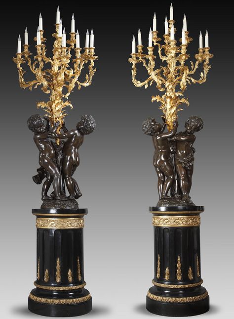 Pair of “Putti” torcheres attributed to bronze-caster V. Paillard, France, circa 1870 A pair of two patina bronze torcheres. Each modelled as a pair of putti holding aloft a large foliate shaft issuing eleven berried-acanthus scrolled branches terminating in conforming drip-pans and nozzles, on a circular parcel-gilt and ebonised plinth with fluted shaft. Rococo Lighting, Antiqued Candle Holders, Marble Fireplace Surround, French Interiors, Crystal Candlesticks, Oak Panels, Art Nouveau Design, French Furniture, Bronze Statue