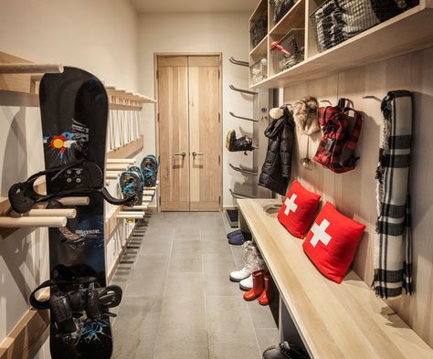 This mudroom (or winter sport storage space) is perfectly designed with light wood cabinets, racks and hooks. A wood bench makes it easy to take off boots, and upper storage spaces with wire baskets keep things organized. Ski Mudroom, Ski House Decor, Gear Room, Ski Room, Sports Storage, Ski Cabin, Light Wood Cabinets, Mudroom Entryway, Ski House