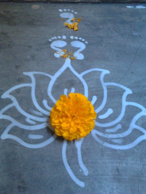 Lotus and Lakshmi footprint by Toshi Lakshmi Footprints Rangoli, Laxmi Footprint, Muruja Jhoti, Jhoti Design, Engagement Couple Dress, Janmashtami Decoration, Alpona Design, Latest Rangoli, Dum Biryani