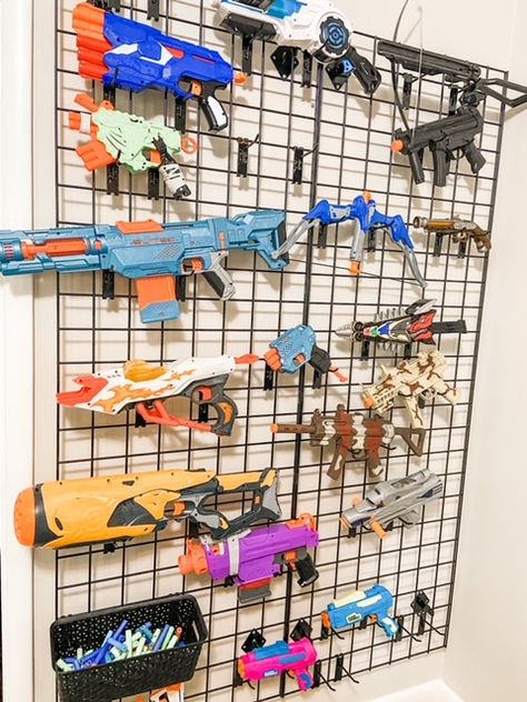 DIY Nerf Gun Wall: How To Organize Nerf Guns - Our Lively Adventures Toy Storage In Basement, Nerfgun Storage, Nerf Armory Wall, Nerf Wall Storage, Nerf Organization Ideas, Nerf Storage Ideas, Nerf Wall, Nerf Storage, Bike Parade