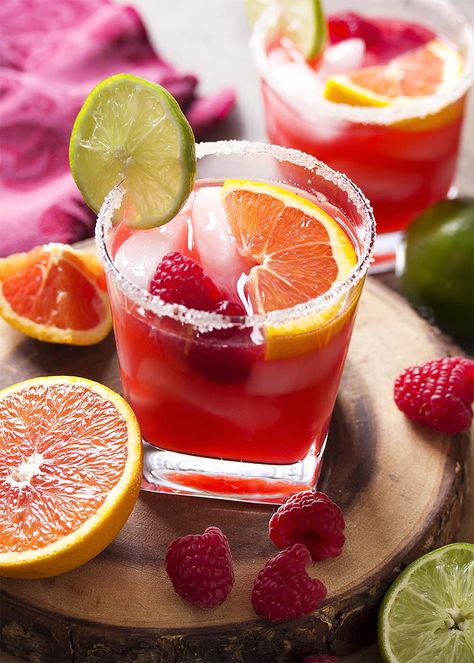 For an easy summer cocktail, try a raspberry orange margarita! Limes, orange juice, raspberry syrup, and triple sec on the rocks. Great for Cinco de Mayo, as for Valentine's, or as an anytime drink! | justalittlebitofbacon.com #summerrecipes #cocktails #drinks #margaritas #valentines #cincodemayo Cocktails With Raspberry Syrup, Raspberry Syrup Cocktail, Valentines Margaritas, Fruity Summer Drinks, Raspberry Margarita, Orange Margarita, Valentine Drinks, Drink Candles, Raspberry Orange