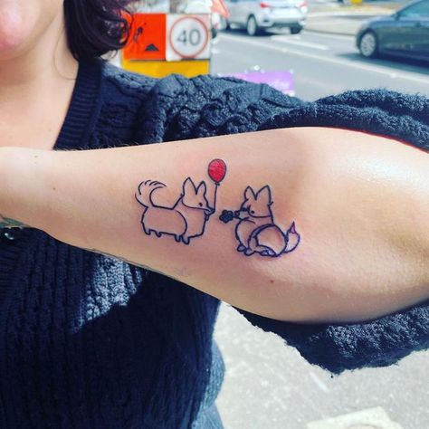 Sugar St Claire on Instagram: "Because Corgis! Image description: a closeup of Claire’s left forearm and new tattoo - line drawings of two cartoon Corgis facing each other. One standing and holding a red balloon in its mouth, the other sitting with a blue flower in its mouth. #corgi #corgitattoo #corgilove #corgis #tattoo #lefthandluckyballarat #mellybulltattoist💞" Corgi Tattoo, Couple Tattoo, St Claire, Line Drawings, New Tattoo, Image Description, Red Balloon, Couple Tattoos, Blue Flower