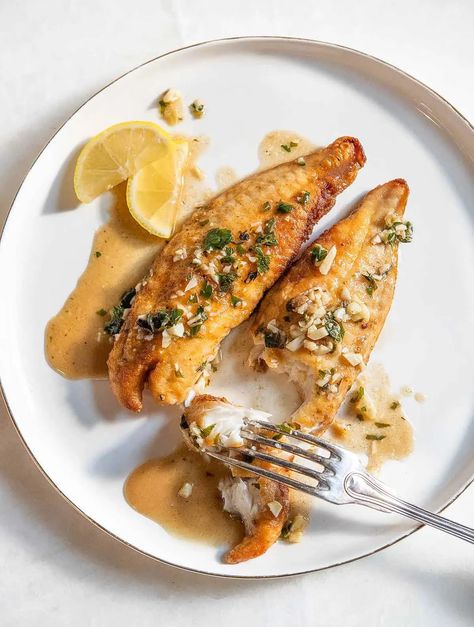 A simple recipe for an extraordinary dinner, Kevin Belton's pan-fried bass is super quick to whip up on a busy weeknight. #panfriedbass #friedfish #lemonbass Garlic Herb Sauce Recipe, Garlic Herb Sauce, Cajun Spice Mix, Pan Fried Fish, Fish Sandwich, Herb Sauce, Bass Fish, Weeknight Dinner Recipe, Light Dinner