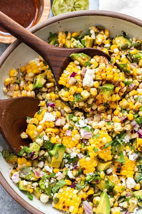 This avocado corn salad is a summer salad made with grilled corn, chunks of avocado, cilantro, queso fresco, pepitas, and a honey lime vinaigrette. Avocado Corn Salad, Chili Lime Vinaigrette, Honey Lime Vinaigrette, Corn Tomato Salad, Honey Chipotle Chicken, Potluck Salad, Corn Avocado Salad, Chicken Caesar Pasta Salad, Cucumber Avocado Salad