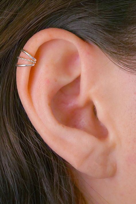 An amazingly pretty new Cartilage Ear Cuff. It features three delicate bands, the middle band is twisted. This piece requires no piercing and sits comfortably on the high ear and simulates a helix piercing. This Ear Cuff is available in these high quality metals: Sterling Silver 14K Gold Filled Rose Gold Filled Two Tone Oxidized Silver  This piece will arrive in a pretty Gift Box and include simple fitting instructions. Perfect for gift giving Helix Piercing Cuff, Upper Ear Percinings, Helix Cuff Piercing, Midi Helix Piercing, Silver Helix Piercing, Upper Ear Piercing Stud, Middle Helix Piercing, High Helix Piercing, Cuff Piercings