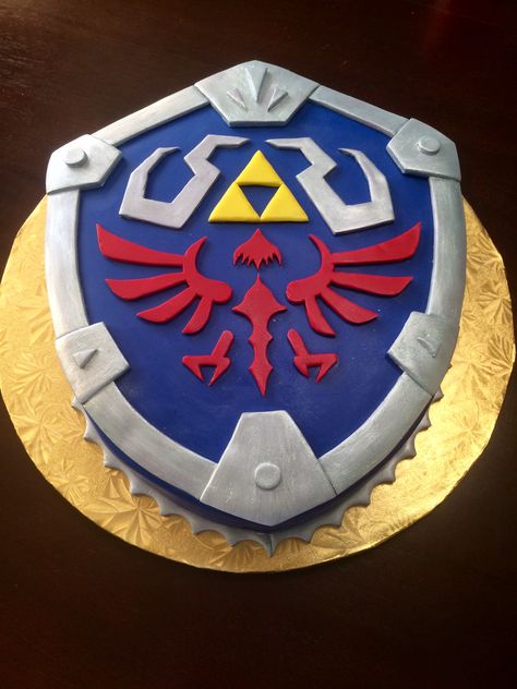 Hylian Shield groom's cake from Legends of Zelda made out of chocolate cake! #GroomsCake #Wedding #ChocolateCake #Zelda #HylianSheild #TheHungryHood Legends Of Zelda, Zelda Cake, Zelda Party, Zelda Wedding, Hylian Shield, Dragon Cakes, Zelda Birthday, Recipes Using Bananas, Cake Wrecks