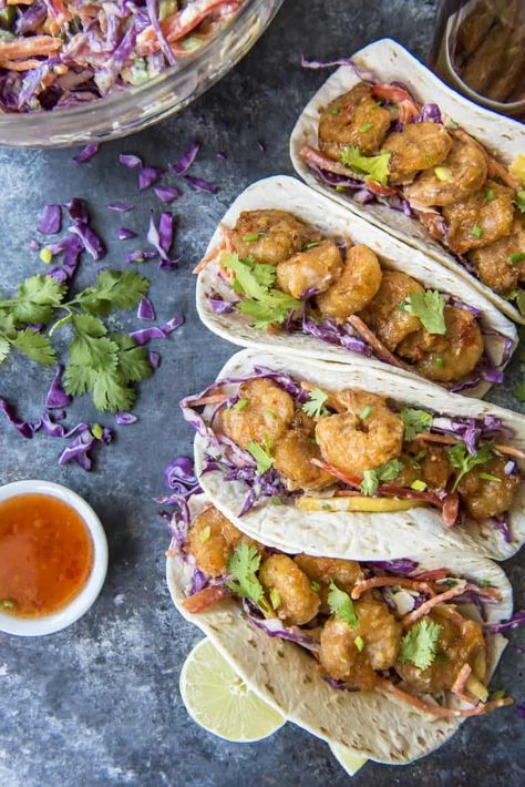 These Bang Bang Shrimp Tacos are where the appetizer meets dinner! Crispy, spicy copycat Bang Bang Shrimp get all wrapped up in your favorite tortillas with a sweet and tangy coconut mango slaw for a flavor explosion that's ready to devour in less than an hour. Coconut Coleslaw, Whipped Chocolate Buttercream Frosting, Whipped Chocolate Buttercream, Bang Bang Shrimp Tacos, Spicy Seafood, Shrimp Taco, Mango Slaw, Shrimp Taco Recipes, Bang Bang Shrimp