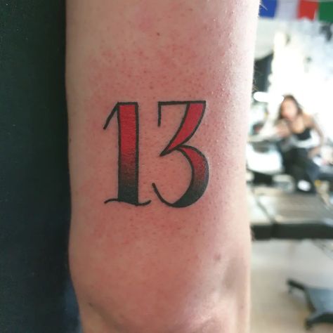 The number 13 has long been associated with both good and bad luck. For some, it's considered an unlucky number that should be avoided. But for others... Lucky Number Tattoo Ideas, Lucky Seven Tattoo, American Traditional Numbers, #13 Tattoo, Unlucky 13 Tattoo, Traditional Numbers Tattoo, Traditional Tattoo Number Fonts, Number 13 Tattoo Designs, Lucky Number 13 Tattoo