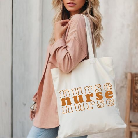 This 100% cotton bag comes in one size – 15 x 16– perfect for everyday wear. While the canvas material will show off your designs in great colors, its durable and will last for years. The bag features 20 handles (made from the same canvas), making it easy to carry even with a weeks worth of Nursing Bag, Nurse Tote Bag, Nurse Tote, Nurse Bag, Nurse Graduation, Canvas Making, Future Nurse, Nursing Graduation, Hospital Bag