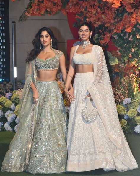 Khushi donned a sleeveless blouse with a scoop neckline, paired with a flowing skirt and a dupatta, all in a milky white hue. The lehenga featured delicate white floral embroidery, cascading elegantly to the floor. She complemented her ensemble with a silky white dupatta adorned with geometric motifs. Jhanvi Kapoor opted for a signature Manish Malhotra creation, featuring a lehenga embellished with intricate gold and silver motifs. Paired with a crystal-studded blouse and matching embroidery... Off White Lehenga Designs, Manish Malhotra Blouse Designs, Jhanvi Kapoor Lehenga, White Bridal Lehenga, Manish Malhotra Lehenga, White Dupatta, Heavy Lehenga, Jhanvi Kapoor, Matching Embroidery