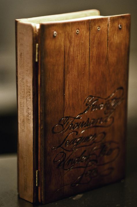 “ “ “ “” ” rickjacques: “ “ “ “ “” ” Finally finished book cover for twenty-thousand leagues under the sea. All handmade Copper spine was etched with acid to reveal the letters, lettering on front was wood burned, inside is a stripped paper back... Wooden Binders, Wood Journal, Book Binder, Book Wrap, Leagues Under The Sea, Leather Bound Books, Wood Book, Book Arts, Wooden Books