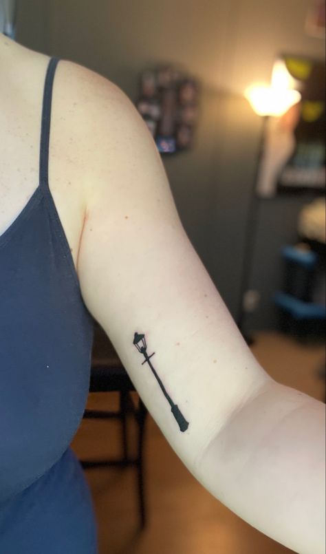 A small black tattoo of the Narnia lamppost on an inner arm above the elbow Subtle Narnia Tattoo, Chronicles Of Narnia Tattoo Ideas, Narnia Inspired Tattoos, Lamppost Tattoo, Narnia Lion Tattoo, Chronicles Of Narnia Tattoo, Narnia Tattoo Ideas, Narnia Lamppost Tattoo, Narnia Tattoo