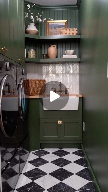 Carol & Ale on Instagram: "LAUNDRY ROOM TRANSFORMATION 🧺 the most useless space in our entire home just got a full makeover, big time! We transformed a 5’ x 7’ laundry room into something very functional and modern.. Everything was wrong with how this room was originally created, from the door swinging in and taking away every bit of working space to basic wall cabinets not being able to stock up all the laundry essentials we needed. It was annoying and ugly and only visited on a daily basis because we needed to wash our clothes! We used front load washer and dryer with pedestals and built the wall cabinets flush with the appliances all the way to the ceiling, maximizing depth and height for storage. Added a farmhouse sink with butcher countertop to give it a soft touch and went moody Dark Green Cabinet Laundry Room, Laundry Room Cabinets And Hanging Bar, Laundry Room Cabinet With Hanging Bar, Laundry Cabinets With Hanging Rod, Laundry Room Upper Cabinets With Rod, 2023 Laundry Room, Checkered Flooring, Modern English Country, Green Laundry