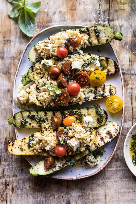 Grilled stuffed zucchini. A healthy vegetarian recipe of tomato, feta, and orzo stuffed inside a grilled pesto zucchini. This quick and easy dish is perfect for spring and summer days and doubles as a healthy dinner or simple side dish. Either way you serve it up, it's going to be a favorite. Zucchini Stuffed, Pesto Zucchini, Grilled Zucchini, Easy Pasta Salad, Half Baked, Half Baked Harvest, Summer Dinner, Zucchini Recipes, Vegetarian Recipes Healthy