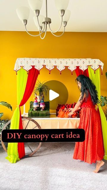 Colourzilla on Instagram: "DIY canopy cart in desi style to display the favors/return gifts this festive season. I created this as part of my golu this year, something that i look forward to every year. Hope you all like it and happy creating!   Happy Navrathri 🌼🌾  I made the canopy structure using pvc pipes by following a youtube tutorial - https://youtu.be/hSA94Iw0T-8   list of items you need to make this -   1. table that you want to display the return favors on 2. pvc pipe cuttings to make the canopy (follow youtube link above) 3. fabric for canopy top (mine here is 5.5 ft x 3ft, purchased at Joann store 4. 2 cart wheels - https://www.athome.com/natural-brown-wooden-wagon-wheel-32/124350012.html?nav=search 5. 7 foot tall draping curtains from amazon  6. safety pins  7. sewing pins fo Diy Cart With Wheels, Draping Curtains, Canopy Structure, Wooden Wagon Wheels, Wooden Wagon, Sewing Pins, Diy Canopy, Pvc Pipes, Return Gifts