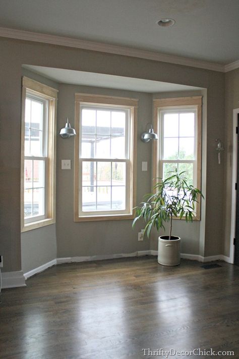 Adding trim to builder windows, the easy way. Add a seating nook, added lighting, easy design, easy woodworking, beginner woodworking Bay Window Benches, Seating In Kitchen, Bay Window Living Room, Kitchen Bay Window, Bay Window Seat, Window Seat Storage, Thrifty Decor Chick, Window Seats, Bow Window