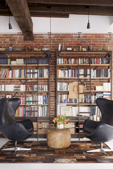 Home library with brick wall backdrop and comfy modern decor Home Library Design Ideas, Modern Industrial Loft, Home Library Decor, Brick Wall Backdrop, Home Library Rooms, Home Library Design, Industrial Interiors, Home Libraries, Interior Design Magazine