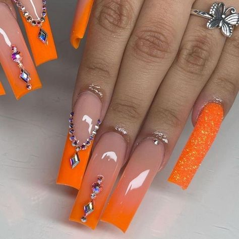 Orange Nails With Jewels, Long Orange Nails With Rhinestones, Yellow Glam Nails, Nails Acrylic Designs Orange, Orange Xl Acrylic Nails, Orange Ombre Nails With Rhinestones, Orange Bday Nails, Orange Bling Acrylic Nails, Neon Orange Prom Nails