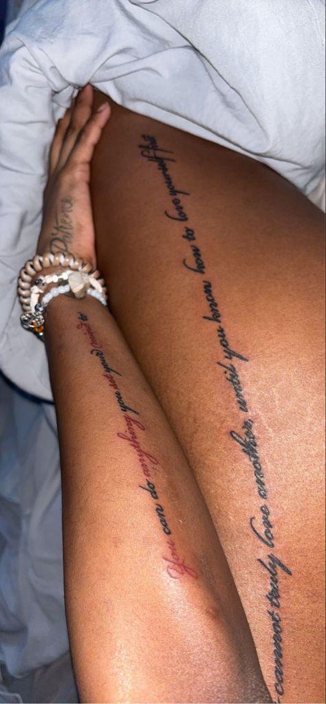 Arm & Leg tattoo, red ink, black ink, cursive, dalals tx Red Ink Dark Skin, Red Ink On Dark Skin, Red Ink Tattoos On Dark Skin, Red Tattoo On Dark Skin, Wrap Around Leg Tattoo Women, Leg Quote Tattoo, Side Leg Tattoo, Black People Tattoos, Dark Skin Tattoo