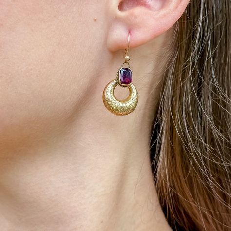 New in An exquisite pair of antique Victorian creole drop earrings featuring two 15ct gold hoops, finely engraved with foliate patterning, and two flat-cut garnets, a combination of oval and cushion cuts, set in rope-edge bezel mounts. They weigh approx. 1.5ct each and have a luxurious cherry-pink hue. They’re a fabulous Victorian pair, dating to the late 19th Century, and dangle beautifully from gold hook wires. Succumb to desire 🌹 Visit our website for an array of gorgeous jewellery all ... Edwardian Engagement Ring, Crimson Red, Garnet Earrings, Memento Mori, Gorgeous Jewelry, Gold Hoops, Antique Jewellery, Antique Victorian, Cushion Cut