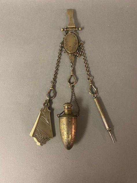 "A lovely Victorian sterling silver chatelaine with etched aesthetic floral, vine & leaf, circa 1880 with all the necessities needed for the Victorian lady. Includes three pendants also with matching etching: a note book with unused paper , a pencil, and a scent bottle with threaded top. In very good condition, marked 926 sterling 38 on the clip. Weight 3.95 ozt.  Measures: 11.25\" Length  Perfume 2.75\" x 1.5\" Pencil 3.25\" x .25\" Note pad 3\" x 1.25\" See photos. Chatelaines became the rage for women of every economic background in the 19th Century. They could be easily customized to your needs, whether you were a society hostess, nurse or secretary. Often fully intact and original chatelaines can tell the story of its owner and as well as her station in life." Chainmaille Jewelry Patterns, Victorian Accessories, Aesthetic Floral, Victorian Lady, Scent Bottle, Note Book, Chatelaine, Floral Vine, Barbie Friends