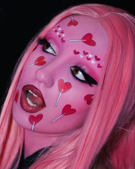 makeup artist wearing a creative makeup look with a pink face and heart shaped red lollipops all over it Makeup Content, College Makeup, Epic Ink Liner, Romantic Makeup, Candy Makeup, Mini Lipstick, Day Makeup Looks, Toy Boy, Face Art Makeup