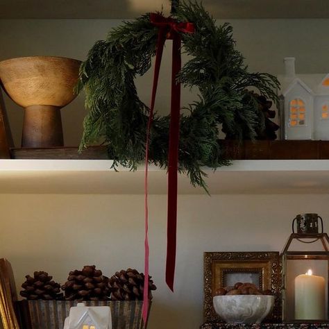 Hanna on Instagram: "Sharing a still of these shelves before my wreath completely dries out! I also recently swapped out the lampshade after being completely influenced by @_homeofvictoria @tkmaxxuk haul (she always finds the best things). It’s such a beautiful deep olive green colour and I must admit it’s love. Not bad for £15! #interiordesignideas #interiordesigninspiration #decemberstyle #shelfstyling #shelfie #shelfdecor #modernvintage #charityshopfinds #myseasonalstory #seasonalstyling #livemoremagic #Christmaswreath #evergreen #homemadewreath #wreathsofinstagram #wreathmaking #christmasdecor #christmas #christmasdecorideas #christmasinspo #christmasstyling #festivemood #festivedecor #christmasideas #Christmasstyle #holidaystyle #holidaydecor #seasonaldecor #seasonalhomedecor #home Christmas Wreaths On Cabinets, Wreaths On Windows Indoors, Shelves Christmas Decor, Diy Tree Ornaments, Deep Olive Green, Minimalist Christmas Tree, Christmas Shoot, Dark Christmas, Cottage Christmas