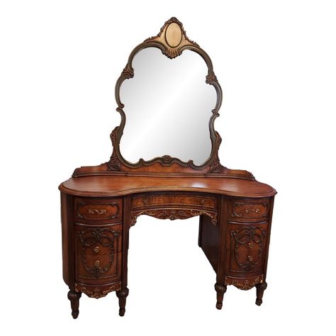 This desk is in excellent condition. It has beautiful accent moldings, gorgeous hardware on the 7 dovetailed drawers. The mirror has a unique curved base. This piece is stunning! Measurements: 52" wide, 21" deep, 30" tall without mirror, 71" tall to mirror Top drawers: 9" wide, 15" deep, 4" tall Middle drawers: 9" wide, 15" deep, 5" tall Bottom drawers: 9" wide, 15" deep, 5" tall Center drawer: 19.5" wide, 10.5" deep, 2.5" tall Antique Vanity Ideas, Vintage Standing Mirror, Light Academia Bedroom, Vintage Vanity Table, Antique Makeup Vanities, Intricate Woodwork, 1920s Furniture, Victorian Style Furniture, Vanity Inspo