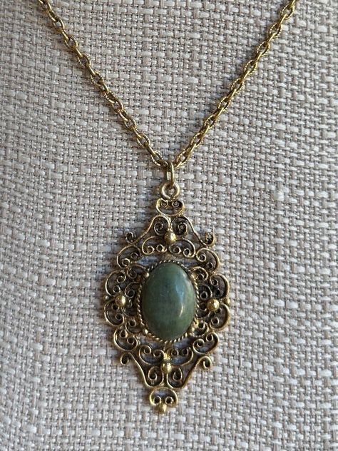 Vintage Victorian Revival Bronze Nephrite Medallion Filigree Necklace 18" Item here is a vintage Victorian Revival bronze filigree medallion necklace with a nephrite stone. This necklace opens and closes with a spring ring clasp. Very neat Victorian design with a lovely green jade stone.  Condition: Great; item is pre-owned and may have some signs of light use and age related wear. Please look closely at the pictures provided as they are an extension of our written description. Measurements: Length: 18 in Chain Width: 3mm Pendant: 2 ⅛ in x 1 ¼ in Weight: 14.8 g 4589C Victorian Pendant Necklace, Fancy Diamond Ring, Victorian Pendants, Victorian Revival, Edwardian Jewelry, Filigree Necklaces, Victorian Design, Jade Necklace, Medallion Necklace