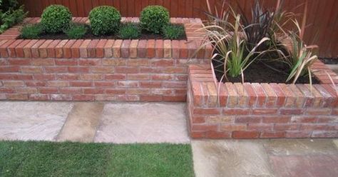 raised brick/stone planters would be great as borders for part of ... Brick Planters, Brick Raised Garden Beds, Brick Raised Beds, Brick Flower Bed, Brick Planter, Brick Garden Edging, Raised Flower Beds, Brick Garden, Farmhouse Landscaping