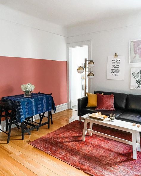 A pink half painted accent wall completes this bright living room. The paint color is Pink Sky by Clare. Coral Paint Colors, Coral Living Rooms, Half Painted Walls, Two Tone Walls, Easy Diy Home Projects, Yellow Paint Colors, Wall Trends, Chicago Apartment, Green Couch