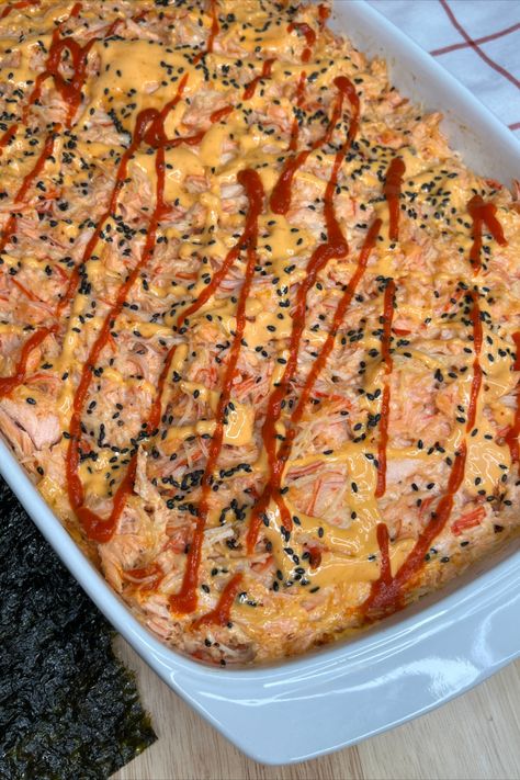 Viral Sushi Bake is a quick and easy way to have sushi at home.  Start with cooked short grain rice mixed with rice vinegar and then add cooked salmon with imitation crab.  A little cream cheese. https://dinasdiner.com/viral-sushi-bake/ Baked Sushi Recipe, Japanese Mayonnaise, Sushi Nori, Crab Sushi, Salmon Appetizer, Sushi Recipes Homemade, Sushi Bake, Seafood Dish Recipes, Sushi At Home