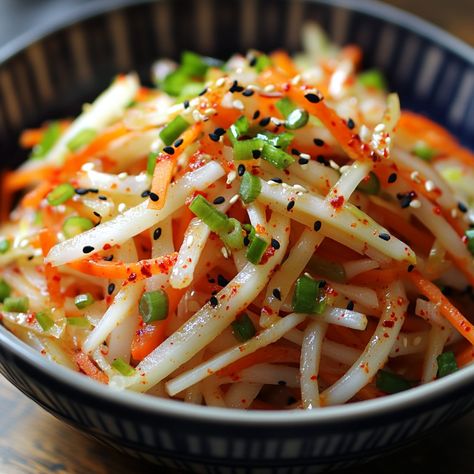 🥕 "Fresh, crisp, and zesty—this Korean Radish Salad is a must-try for your next meal!" 🥕 #KoreanSalads #FreshAndZesty Korean Radish Salad Ingredients: Korean radish (1 medium, peeled and julienned) Carrot (1 medium, julienned) Green onion (2, chopped) Red pepper flakes (1 tsp) Rice vinegar (2 tbsp) Sugar (1 tbsp) Soy sauce (1 tbsp) Sesame oil (1 tsp) Salt (½ tsp) Instructions: In a bowl, mix radish, carrot, and green onion. Combine red pepper flakes, rice vinegar, sugar, soy sauce, sesame... Chinese Carrots, Korean Radish, Daikon Radish, Julienned Carrots, Radish Recipes, Instagram Recipes, Radish Salad, Foreign Food, Korean Recipes