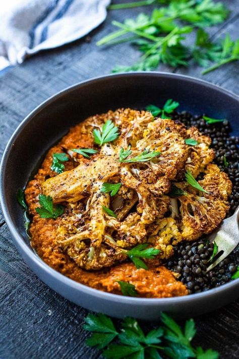 Roasted Cauliflower Steaks with Romesco Sauce over a bed of simply seasoned lentils. A simple, easy vegan dinner made on a sheet pan! Seasoned Lentils, Fancy Vegetarian Dinner, Cauliflower Steaks Recipes, Bright Line Eating Recipes, Salty Recipes, Feasting At Home, Roasted Cauliflower Steaks, French Green Lentils, Plant Based Recipes Dinner