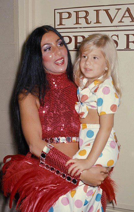 1. Chastity sits on her mother Cher's lap after a show in 1974. (Photo: Globe Photos) 70s Television, Cher 1960s, Cher Fashion, Chaz Bono, Cher Show, Cher And Sonny, Cher Outfits, Cher Photos, Sonny And Cher