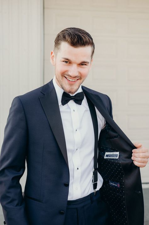 Groom wearing a custom midnight blue suit with peak lapel, black-and-white polka dot silk lining, black suspenders and bow tie for black-tie wedding. Photo by Sandra Monaco.  #BlackTieWeddingInspiration #GroomInspiration #BlackTieWedding #CustomSuitInspirationforWedding #FortheGroom #AncasterMillWedding Navy Blue Groom Suit Bow Tie, Midnight Blue Wedding Suit Grooms, Groom Suit With Suspenders, Midnight Blue Wedding Suit, Midnight Blue Suit Wedding, Navy Suit Black Lapel, Navy Suit With Bow Tie, Blue Suit With Bow Tie, Groom With Suspenders