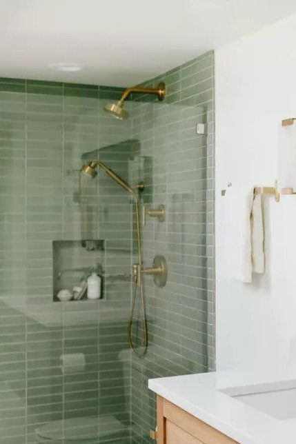 Behold another essay on why green should most definitely be part of your minimalist bathroom. Muted shades of green act like neutrals and pair beautifully with the rest of the quiet colors and textures in your Scandinavian-style space. #scandinavianhomedecor #minimalistbathroomideas #mydomaine #hyggehomedecor #cozybathroomideas #scandinavianbathroomideas Green Floor Bathroom Ideas, Green Tones Bathroom, Green Bathroom Mid Century, Earthy Bathrooms Earth Tones, Green White Bathroom Ideas, Light Green Tile Shower Ideas, Scandinavian Bathroom Tile, Modern Scandi Bathroom, Scandinavian Master Bath