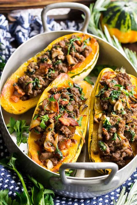 Delicata squash is roasted to perfection and stuffed with ground beef, caramelized onions, bacon, spinach, mushrooms and seasonings.  This cozy paleo and Whole30 stuffed squash is great for any meal or as a side dish.   Savory, filling and healthy! Bacon Stuffing, Paleo Acorn Squash, Sausage Stuffed Acorn Squash, Delicata Squash Recipe, Paleo Dinners, Stuffed Squash, Stuffed Acorn Squash, Ground Beef Recipe, Monthly Menu